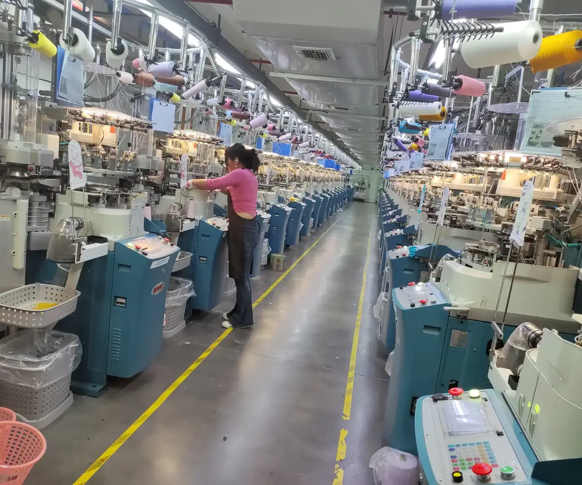 QYQ Socks production operator checking knitting machines